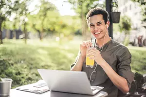 Smiling student is learning French online